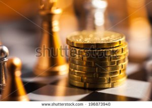 stock-photo-coins-on-a-chess-board-finance-concept-196873940